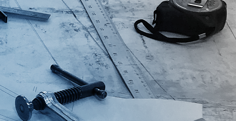 ruler and stapler on drafting table