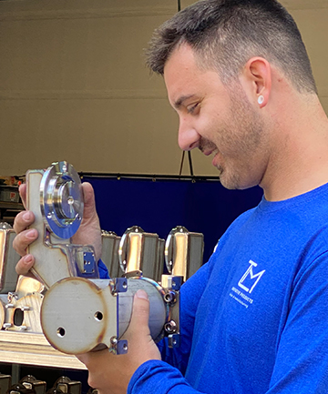worker holding espresso brew tank